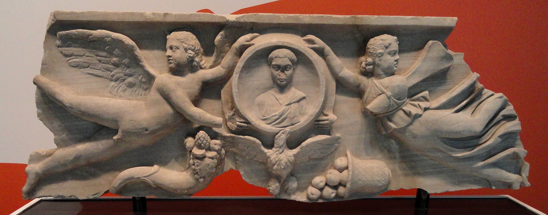 Roman sarcophagus fragment: Cupid and a butterfly-winged Psyche beside a portrait of the deceased.